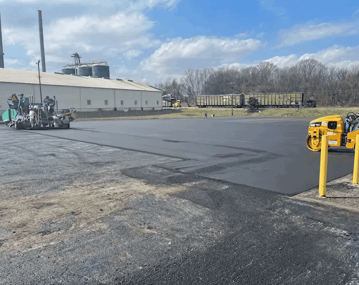 Freshly paved industrial area with machinery