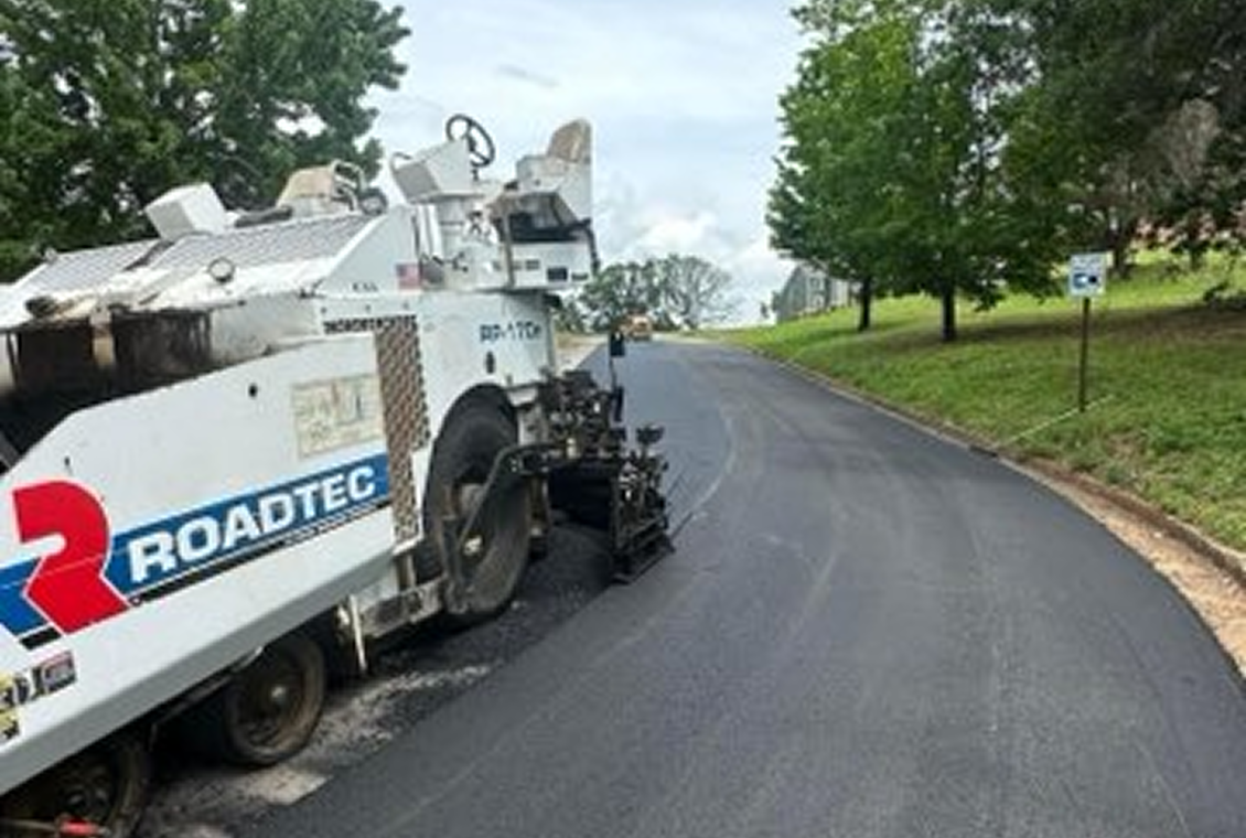 Road paving machine on freshly laid asphalt